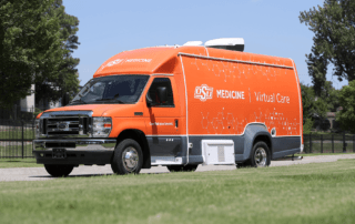 A large orange Ford OSU Medicine virtual care vehicle.